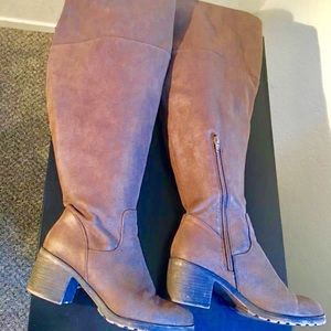 Brown knee high riding boots.